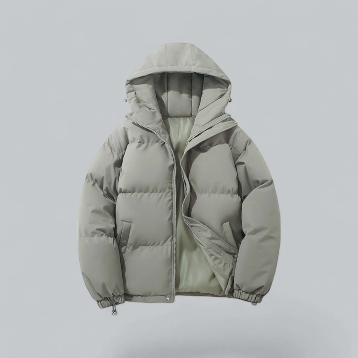 Pale sage green quilted jacket with hood, zip partly open showing the light lining and drawcord at the cuffs. 5