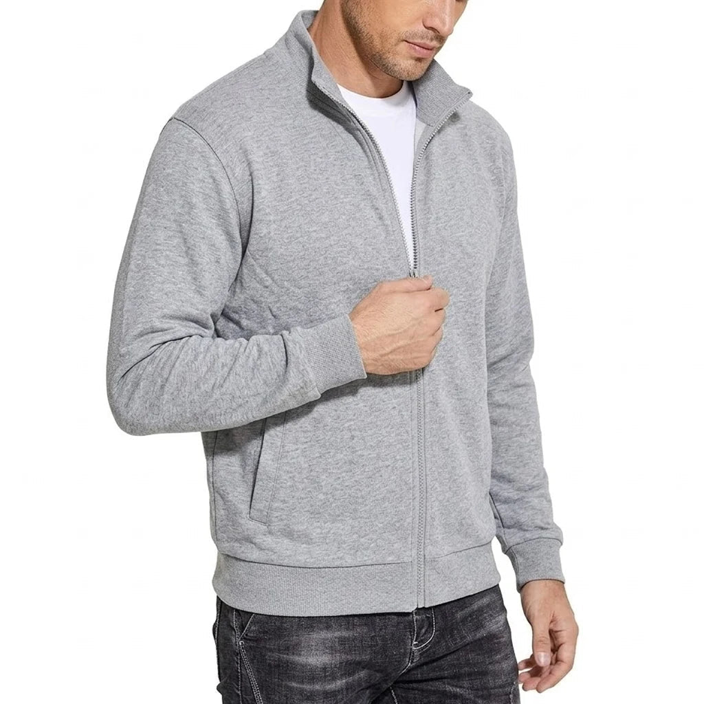 Angled three-quarter view of the light grey marl zip jacket, with the model holding the zip and ribbed cuffs and hem visible. 2