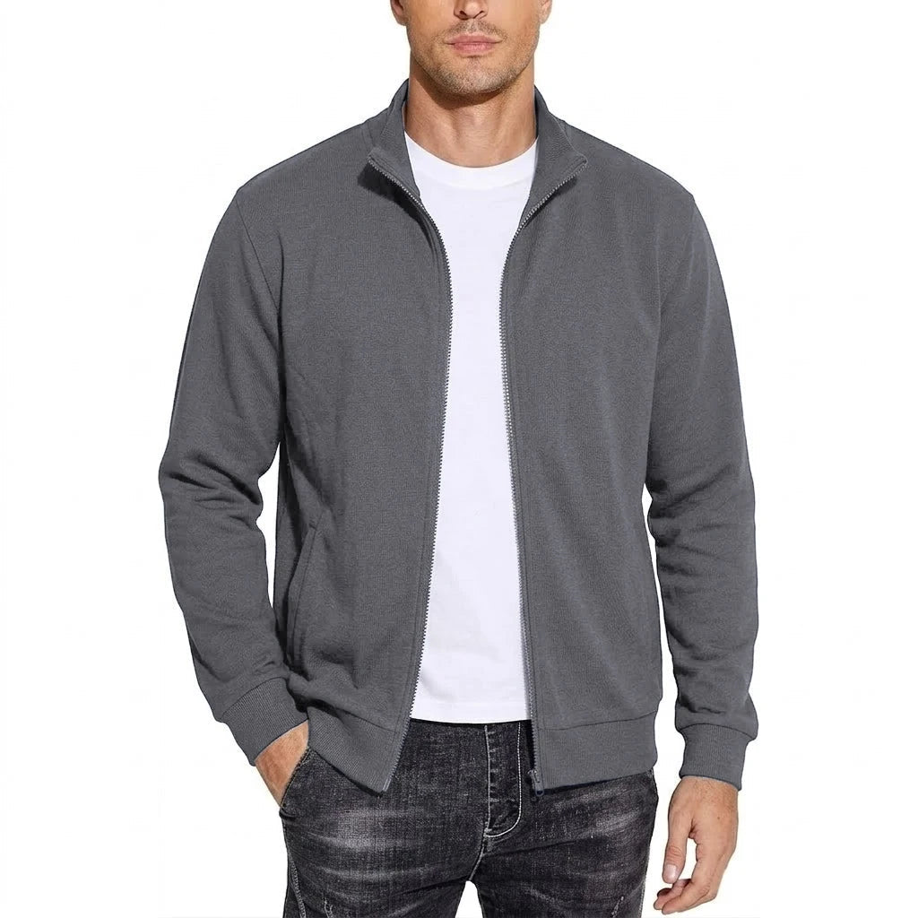 Model wearing the stand-collar sweatshirt jacket in mid grey, unzipped over a white T-shirt, showing ribbed cuffs and hem. 5