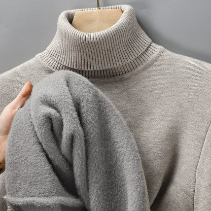 Beige turtleneck jumper on a hanger, with a hand showing the soft grey fleece lining inside 6