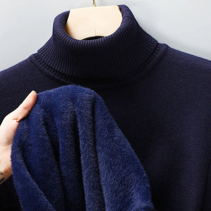 Navy turtleneck jumper on a hanger, with a hand showing the plush blue fleece lining inside 7