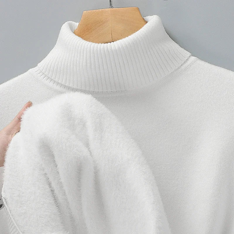 Cream turtleneck jumper on a hanger, with a hand pulling out its soft, fluffy inner lining 5