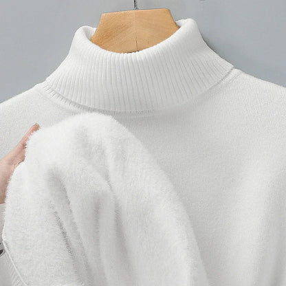 Cream turtleneck jumper on a hanger, with a hand pulling out its soft, fluffy inner lining 5