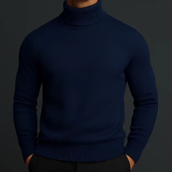 Model wearing the navy turtleneck jumper with ribbed collar and hem, hands in black trousers 3