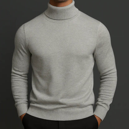 Model wearing the light grey turtleneck jumper with ribbed collar and cuffs, hands in black trousers 2