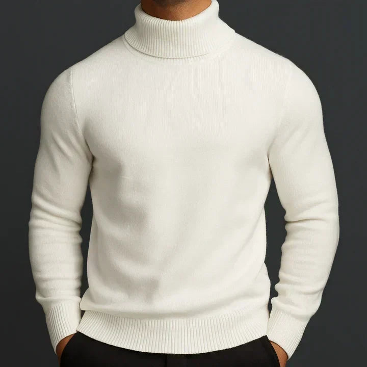 Model wearing the cream turtleneck jumper with ribbed collar, cuffs and hem, hands in black trousers 1