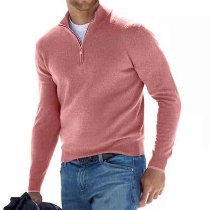 Model walking in the jumper in dusky pink with a half zip, worn over a white tee and blue jeans. 3