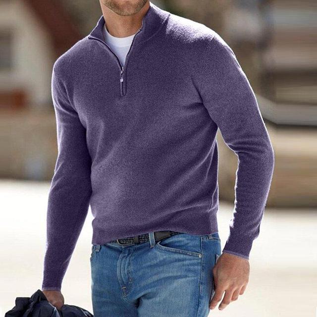 Model walking outdoors in the jumper in purple with a half zip, worn over a white tee and blue jeans. 5