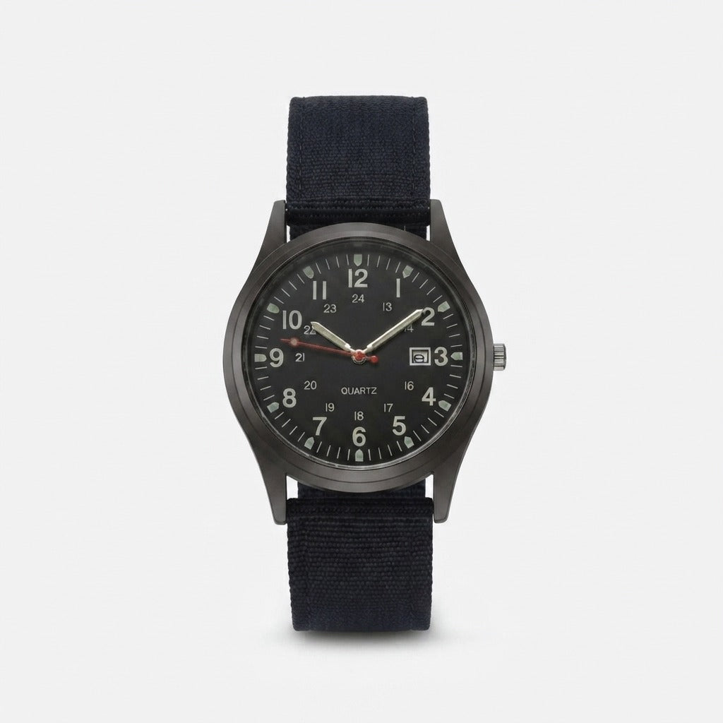 Second front view of the black-dialled watch with luminous hands, red seconds hand and black nylon strap on a light background. 9