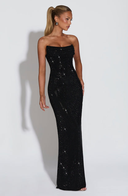 Three-quarter side view of the black sparkling strapless gown, showing its fitted silhouette and floor-length hem 25