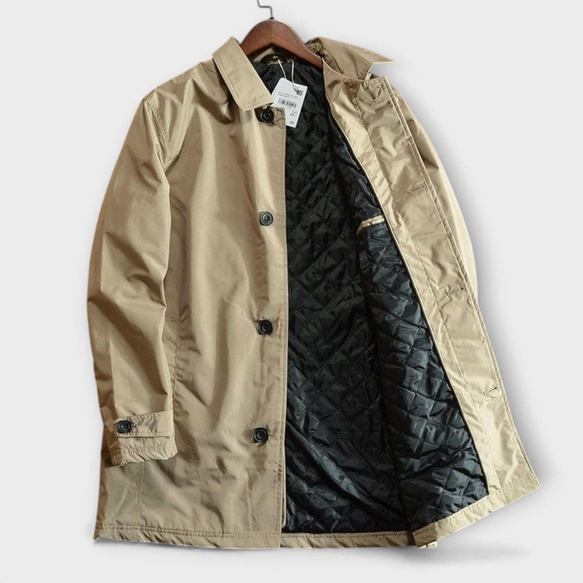 Beige coat on a hanger with buttoned front, collar and black quilted lining visible inside 7