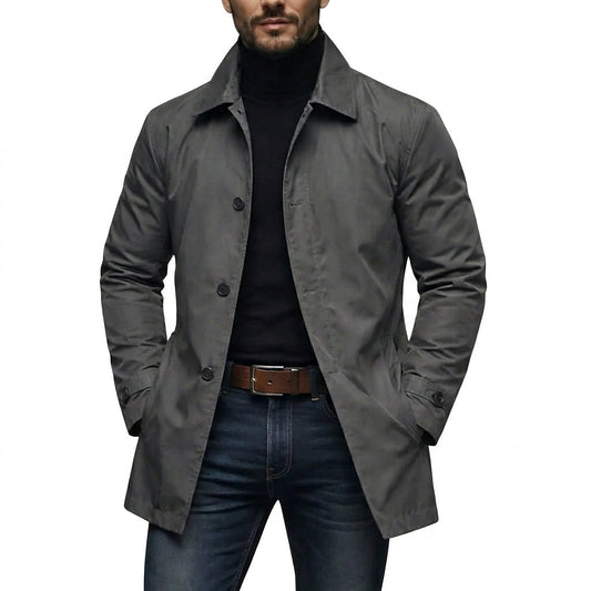 Model wearing the grey coat open over a black roll-neck, jeans and brown leather belt, hands in pockets 1