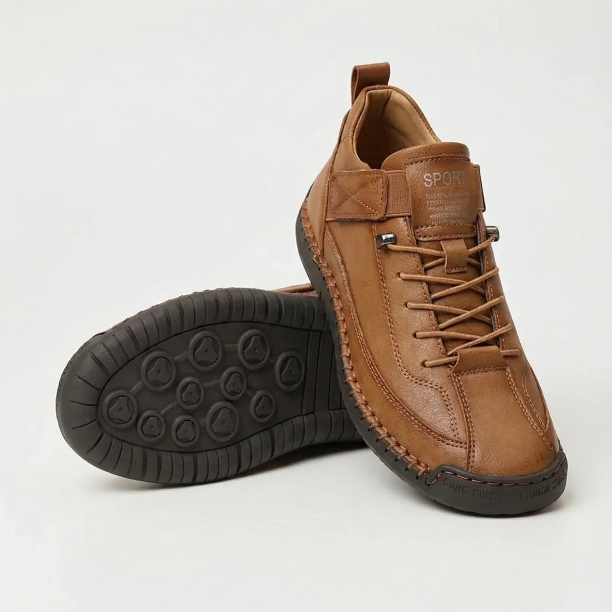 Tan brown leather-look trainers with contrast stitching, one upright, one sole-up showing dark circular tread 4