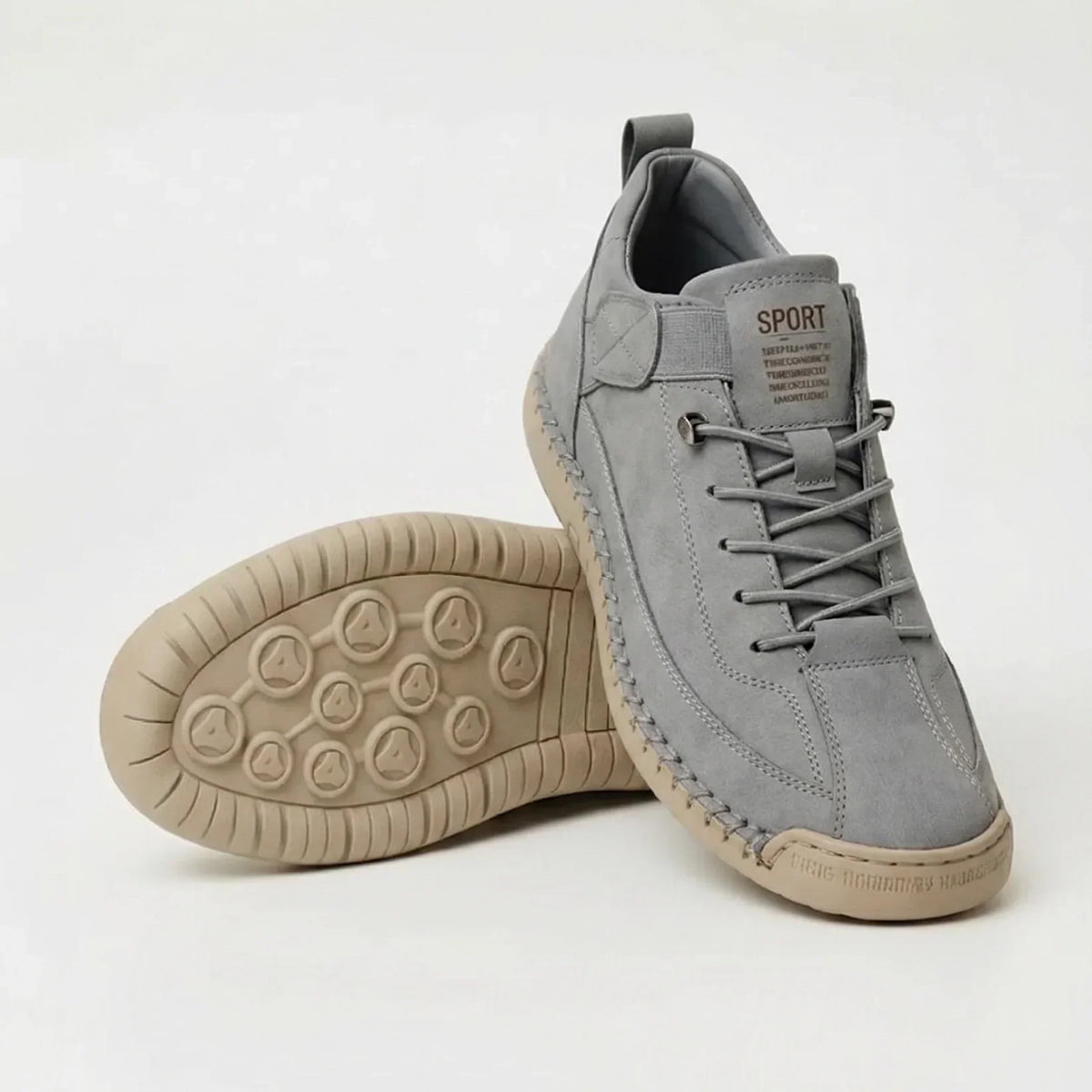Light grey suede-look trainers with tan sole, one standing, one tilted to reveal the circular grip pattern 8