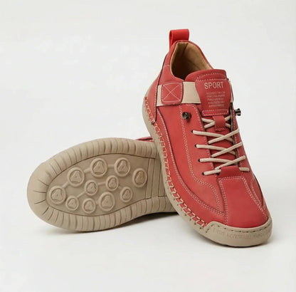 Red trainers with cream laces, elastic strap and tan sole, one upright, one showing its tread 9