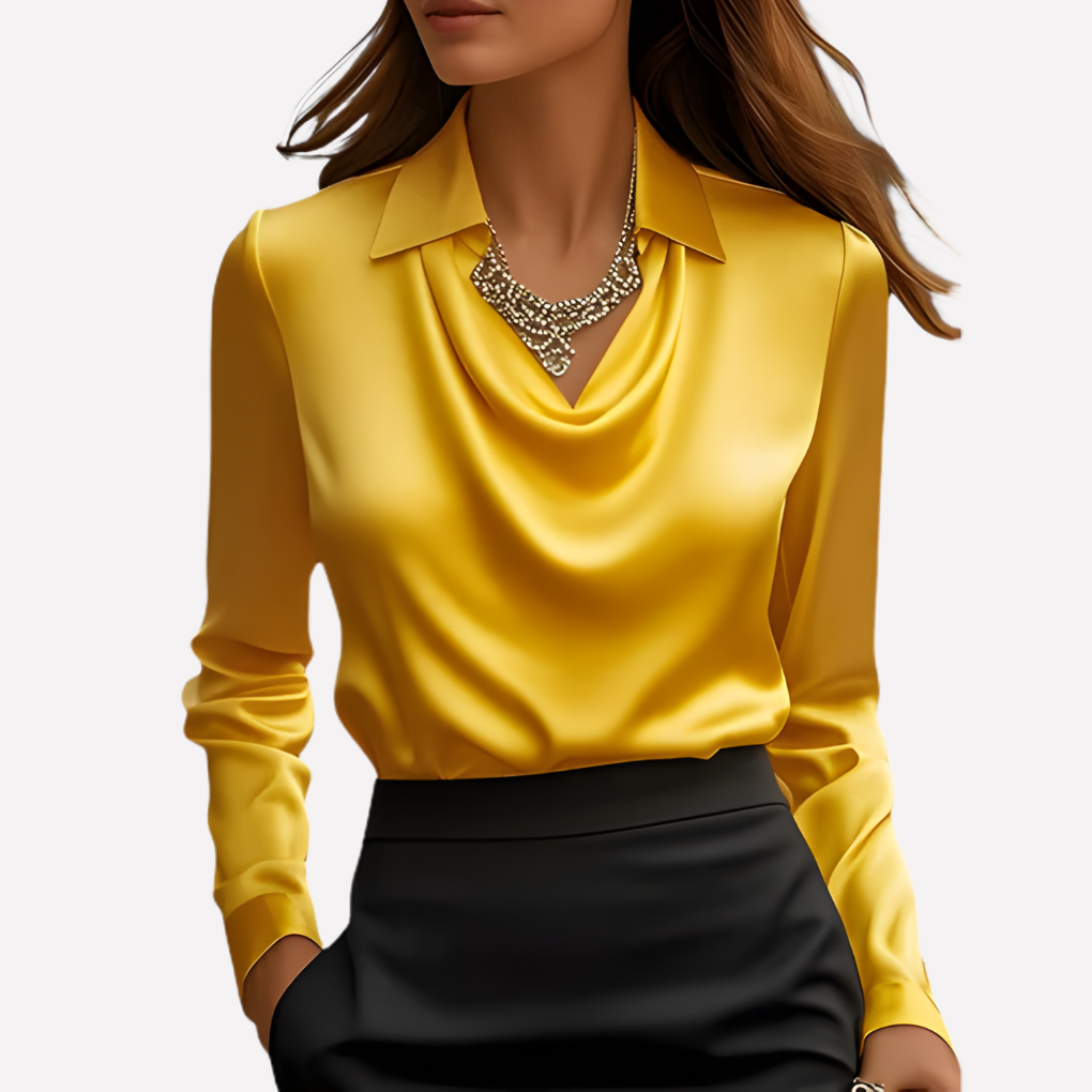 Model wearing the bright yellow satin blouse with cowl neckline and collar, with a statement necklace and black skirt 10