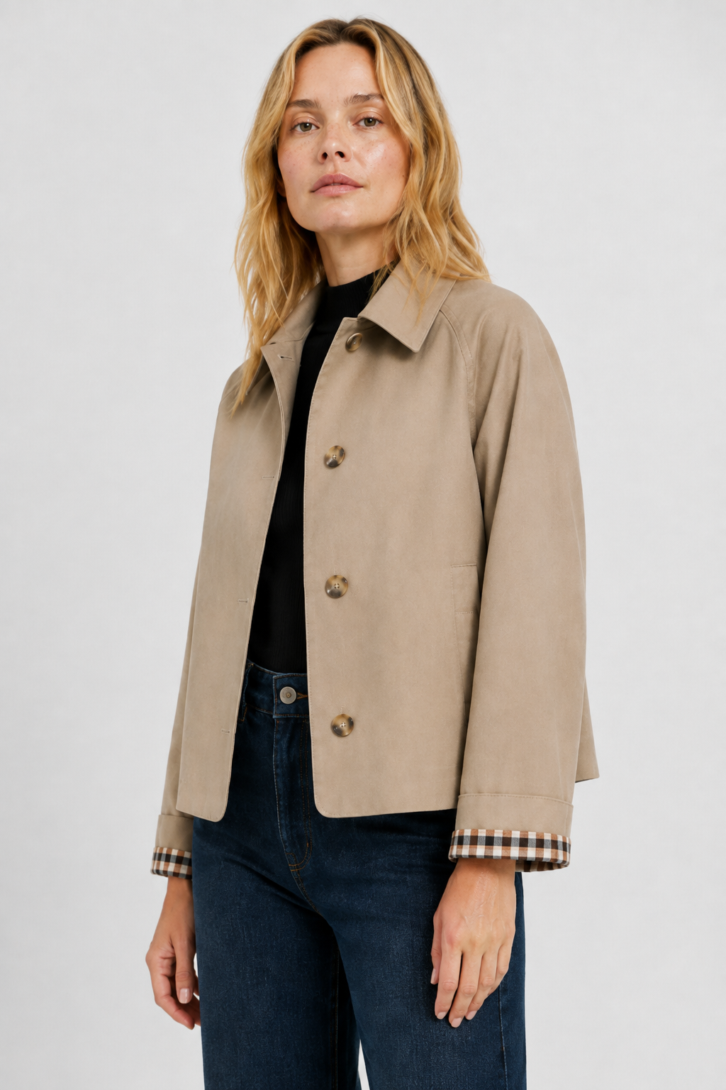 Beige jacket on a model in three-quarter view, showing the collar, horn-style buttons and turned-back gingham cuffs. 2