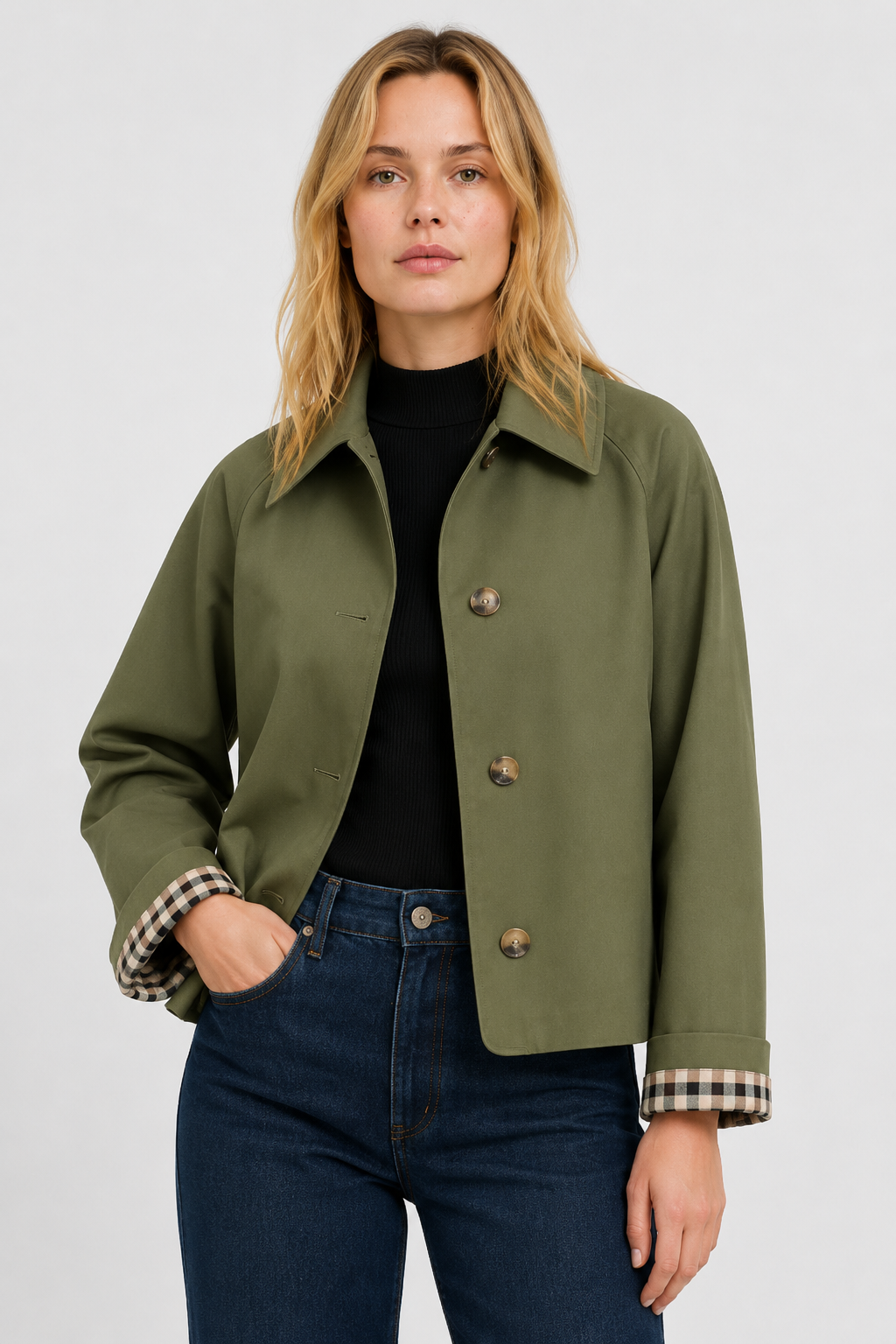 Model wears the olive green jacket over a black top and jeans, hand in pocket, gingham cuff lining showing. 7