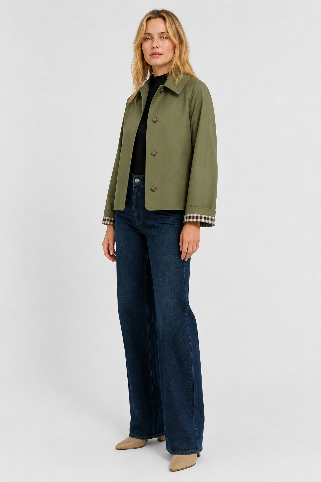 Olive green jacket in full-length three-quarter view, worn buttoned with dark jeans, beige boots and gingham cuffs. 11
