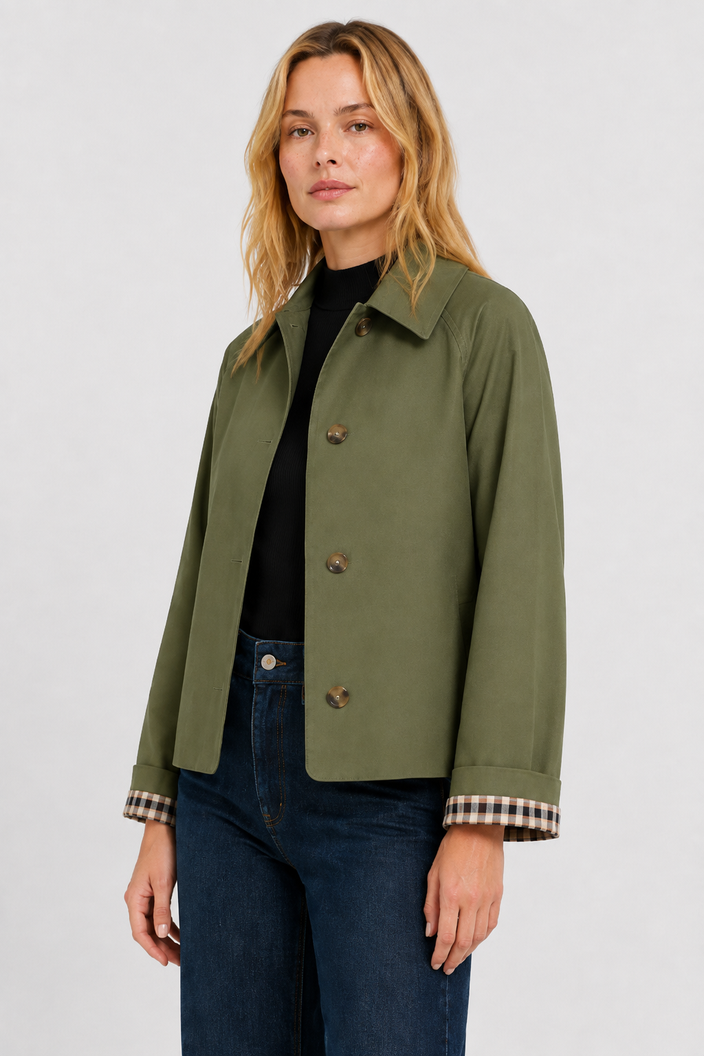 Olive green jacket in three-quarter view, showing the pointed collar, front buttons and gingham-lined turned-back cuffs. 8