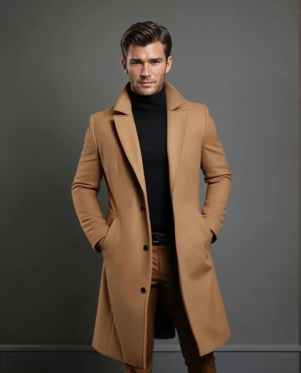 Full-length view of the camel coat on a model with swept-back hair, showing the lapels, three buttons and knee-length cut. 5