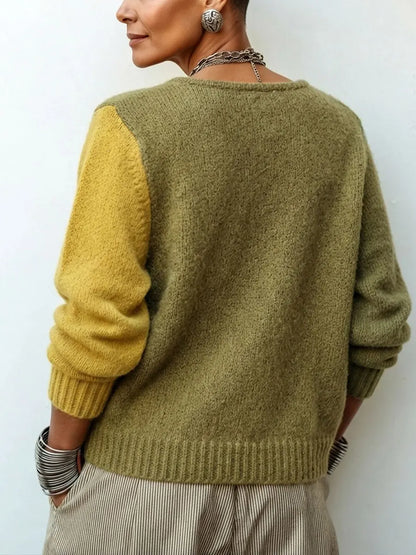Back view of the knit, showing an olive back panel, one mustard sleeve and ribbed cuffs and hem 3