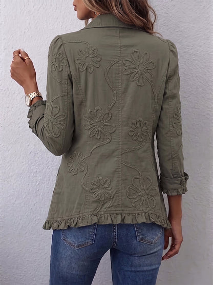 Back view of the olive green jacket worn by a model, showing large raised floral embroidery and a ruffled hem. 2