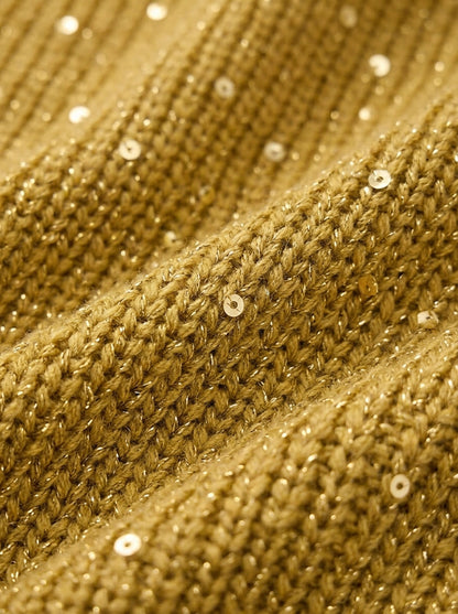 Close-up of the gold chunky ribbed knit fabric, with small sequins and metallic thread glinting between the stitches. 7