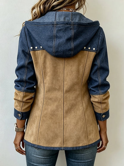 Back view of the jacket on a model, showing the blue denim hood, studded yoke, tan panelled back and button cuffs. 2