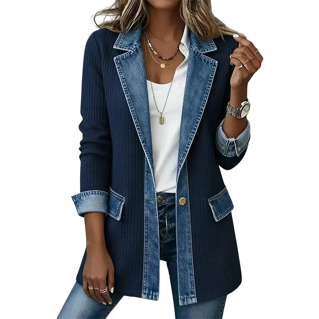 Navy ribbed blazer-style coat with denim lapels, flap pockets and a single gold button, worn over a white top. 17