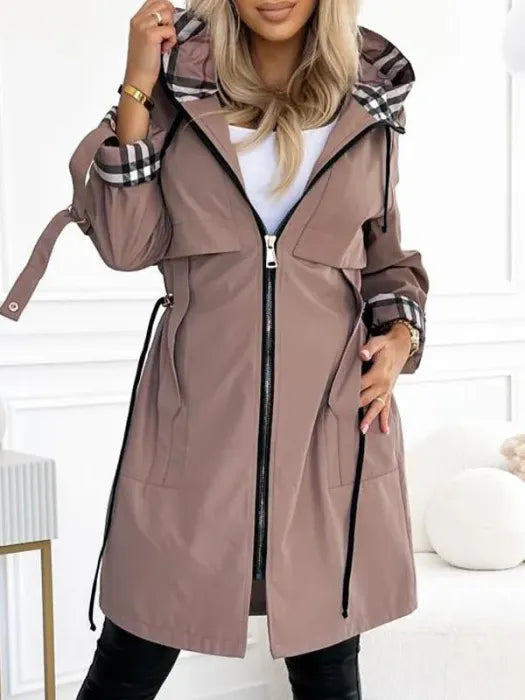 Model wearing the mauve-brown hooded jacket zipped open over a white top, with checked lining on the hood and cuffs and waist drawcords. 1