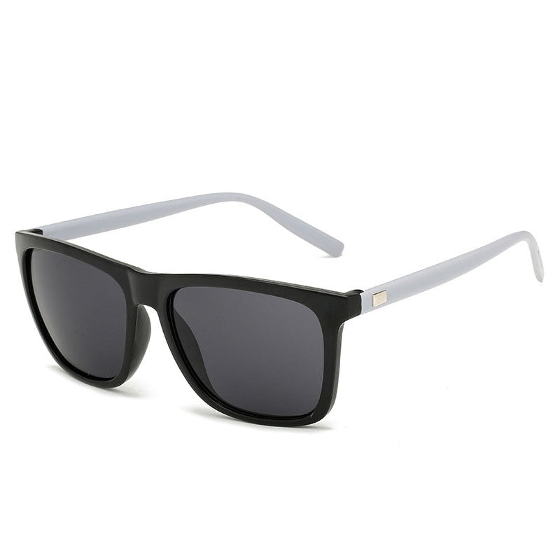 Angled view of sunglasses with a black front, light grey arms and dark grey lenses 12