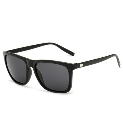Angled view of matte black sunglasses with dark grey lenses and a small metal plate on each arm 7