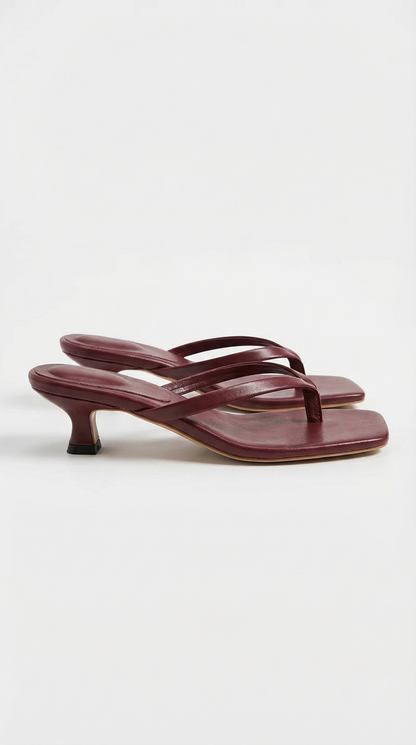 Pair of deep burgundy kitten-heel thong sandals with square toes and a flared heel, shown from the side. 13