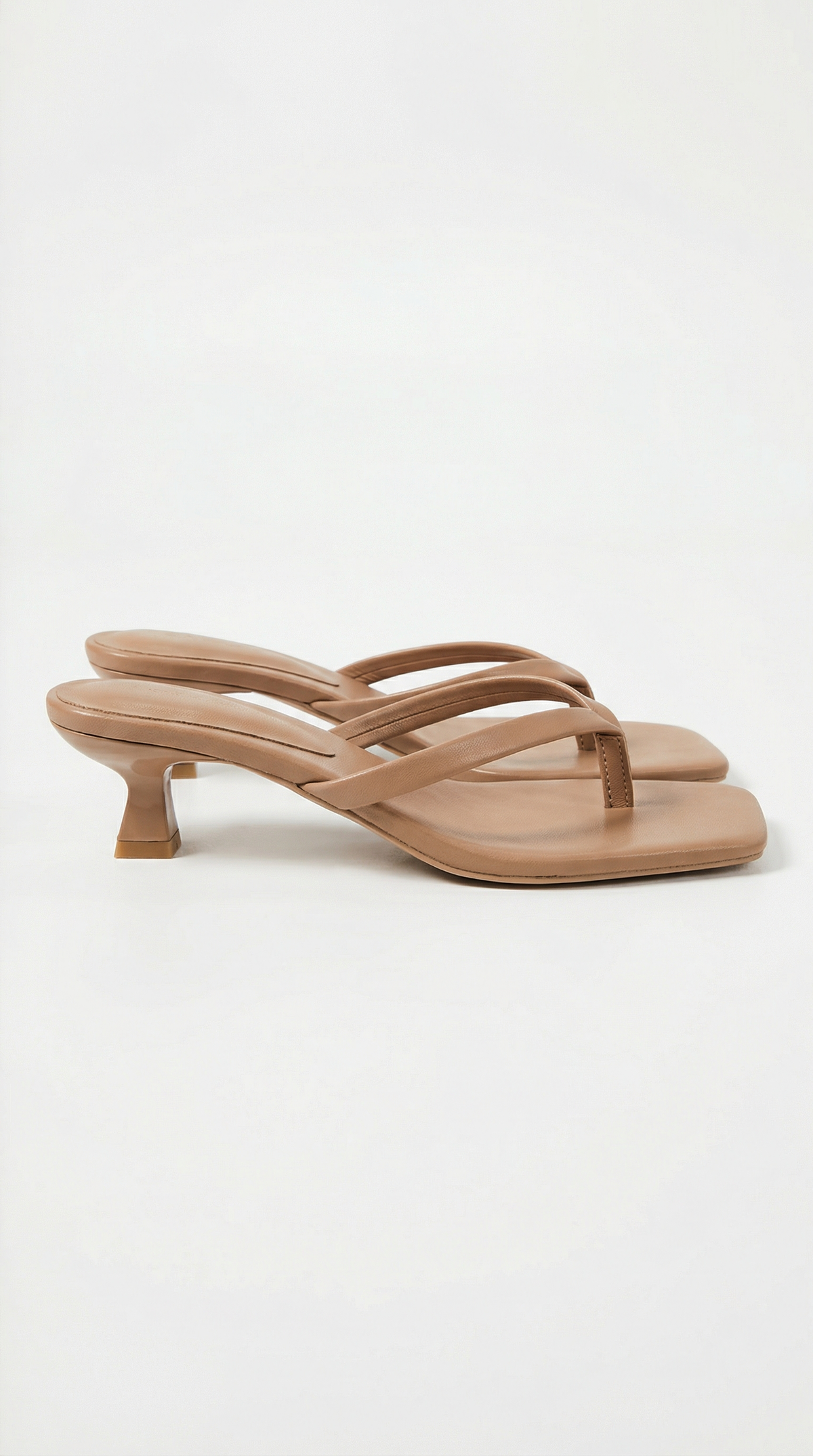 Pair of tan kitten-heel thong sandals with padded straps and square toes, shown from the side. 7