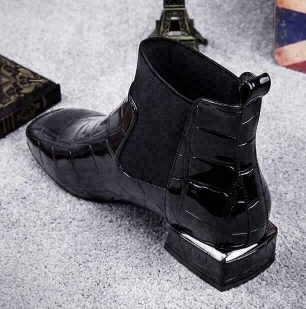 Rear three-quarter view showing the pull tab, panelled heel counter and metallic trim on the block heel 3