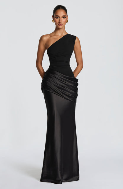 Front view of the burgundy dress with hands tucked behind, showing the drape across the hip and satin skirt. 39