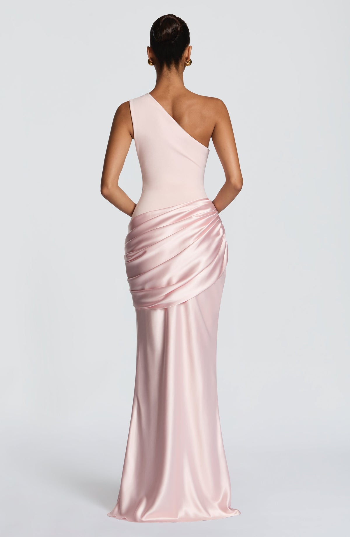 Front view of the dress in pale blush pink on a model, with pleated bodice and draped satin hip panel. 28