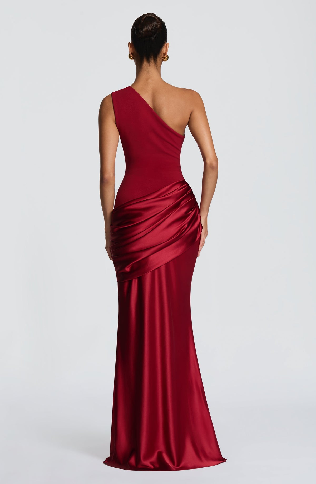 Back view of the red one-shoulder maxi dress, with the diagonal strap and gathered satin hip drape. 16