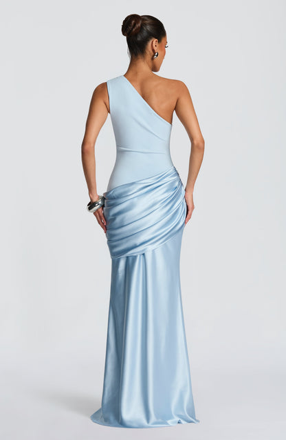 Back view of the pale blue dress showing the asymmetric one-shoulder strap and gathered satin hip drape. 3