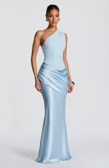 Front view of the pale blue one-shoulder gown with ruched satin drape at the hip, worn with silver jewellery. 2