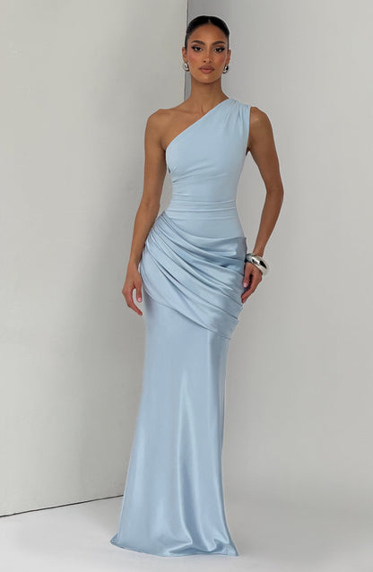 Pale blue one-shoulder satin maxi dress worn by a model standing against a light grey backdrop. 4