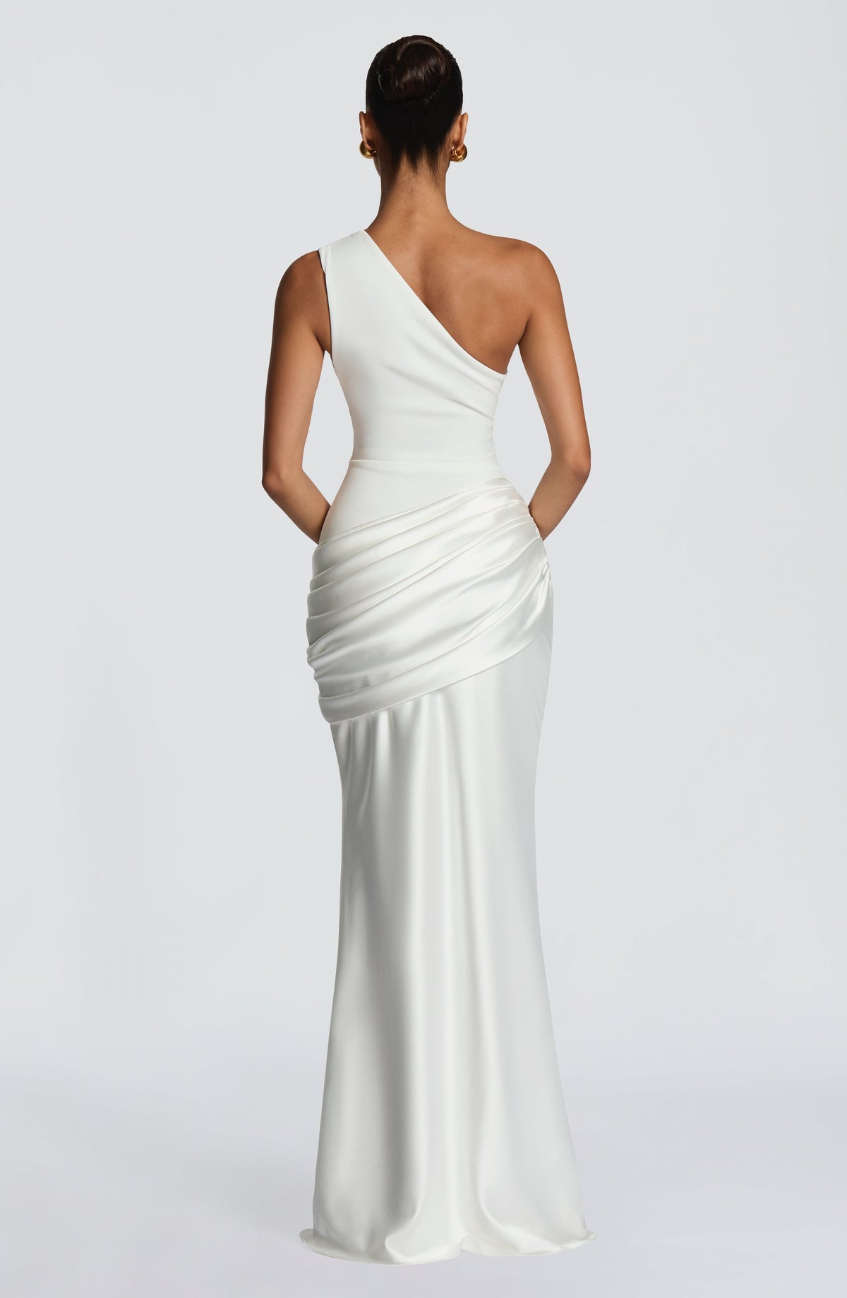 Back view of the white one-shoulder maxi dress, showing the asymmetric strap, plain back and draped satin hip. 23