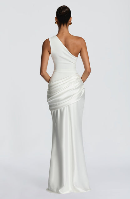 Back view of the white one-shoulder maxi dress, showing the asymmetric strap, plain back and draped satin hip. 23