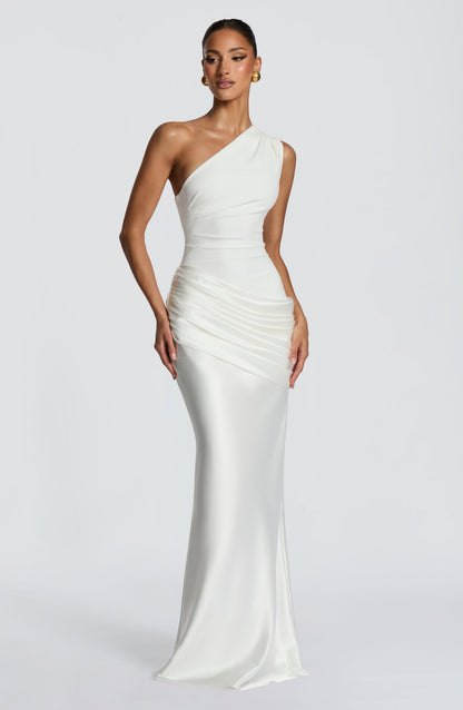 Front view of the white maxi dress with the model's hands resting at the sides, showing the draped hip panel. 26