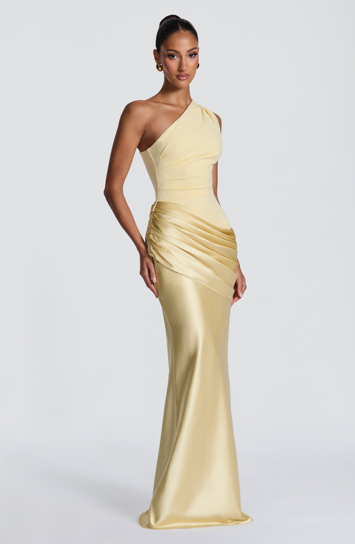Three-quarter side view of the pale yellow maxi dress, with a fitted bodice, ruched hip detail and fluted satin hem. 47