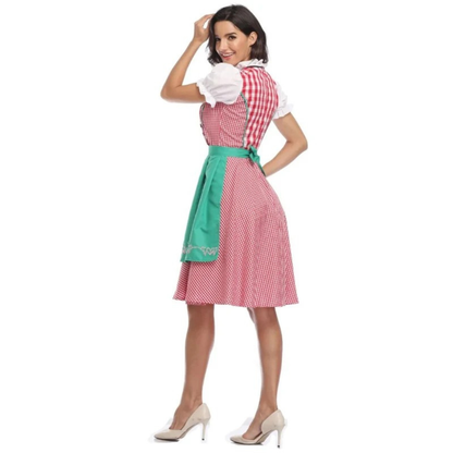 Back view of the red check dirndl with green apron tied in a bow, the model smiling over her shoulder. 10