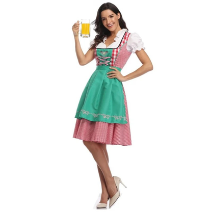Full-length view of the dirndl with a green apron over red check, worn with a beer glass and cream heels. 4