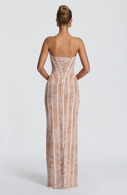 Back view of the blush pink lace dress, showing the corset lacing with a bow tie and the slit at the centre back hem. 14