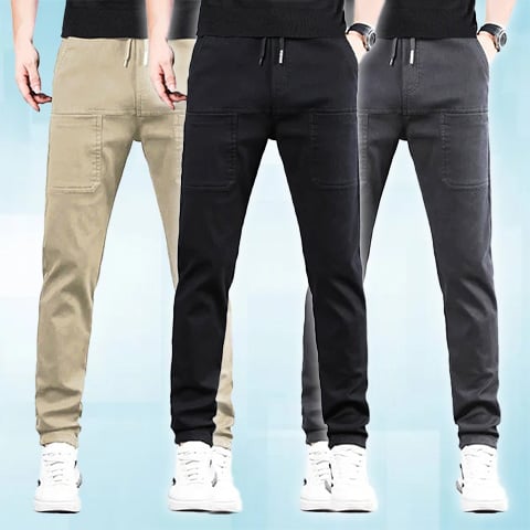 Three men side by side wearing the drawstring trousers in beige, black and dark grey 24